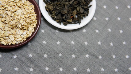 Oatmeal in a plate. Raw oatmeal, healthy food concept. Dry tea leaves. Nice breakfast. Healthy food concept. vegetarian food.