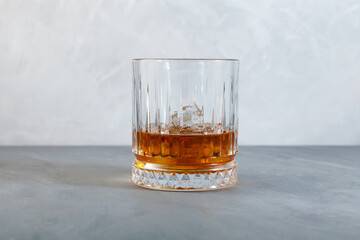 Whiskey on the rocks or scotch with ice cubes. Old fashion glass, copy space