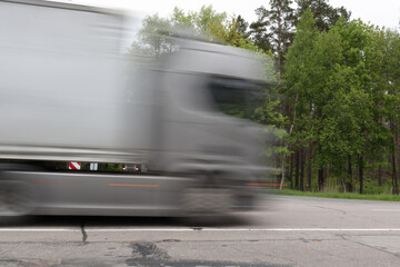 Truck with semi-trailer driving at high speed. Motion blur
