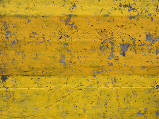 Old yellow concrete wall with chipped paint