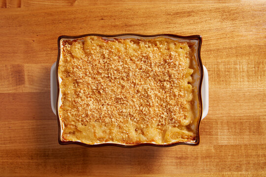 Top View Of Mac N Cheese In A Ceramin Baking Pan On A Wooden Surface