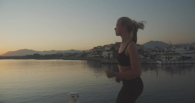 Beautiful Athlete Jogging Along Promenade At Sunset