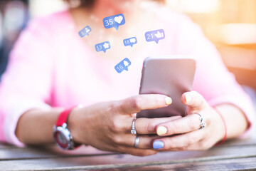 A girl uses a smartphone while spending time in social networks, getting likes and subscribers