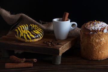 aromatic black tea with cinnamon on a wooden background with dessert. Coffee break. 