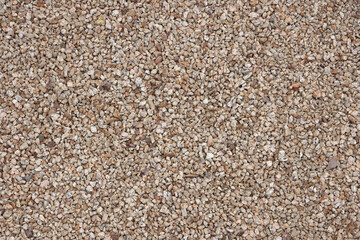 Light brown gravel stones in a high angle full frame close-up view 