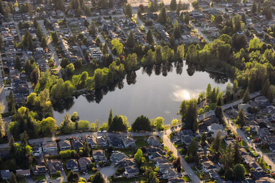 Aerial View from an Airplane of Residential Homes near a pond in Coquitlam, Greater Vancouver, British Columbia, Canada. Como Lake Park