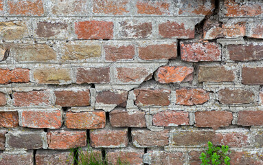 Old brick wall. Red brick wall. Brick wall with a crack in the middle. background texture