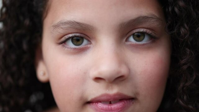 Hispanic little child opening eyes smiling. Latina girl kid open eye