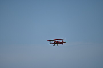A world war II biplane flying in the blue sky	
