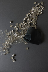 old, worn, recycled square pyramidal metallic studs or spikes arranged in the shape of a line with...