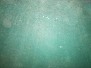 teal blue underwater blured swimming when waves rushing into
