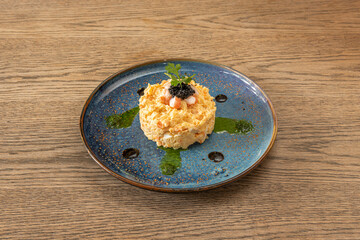 serving of Russian salad with assorted sauces to serve as a spanish tapa in a bar