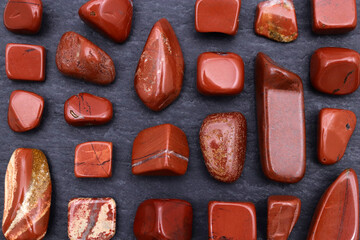 Red jasper rare jewel stones texture on black stone background
