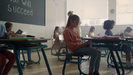 Children using digital tablets at lesson. Girl holding tablet computer
