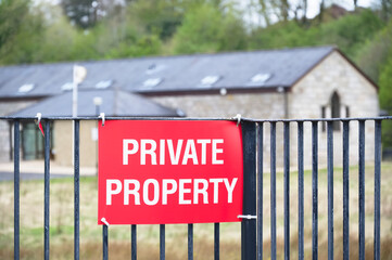 Private property red sign on entrance gate