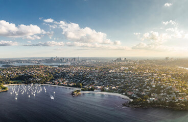 Fototapeta premium Stunning high angle aerial drone view of Balmoral Beach and Edwards Beach in the suburb of Mosman, Sydney, New South Wales, Australia. CBD, North Sydney and Chatswood in the background left to right.