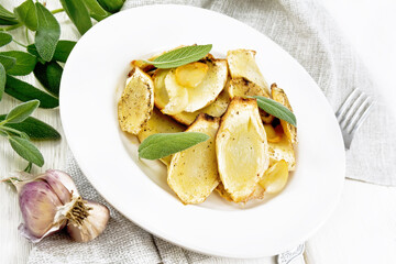 Parsnips baked in plate on white wooden board