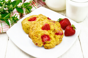 Scones with strawberry in plate on wooden board