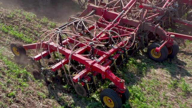 A close-up of grass collection equipment. The farmer collects plants for feed cattle, forage. Green field in summer. Processing the vegetative parts of plants. High quality. 4k footage.