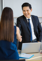 Anonymous woman with resume in hand standing in office with male manager before interview