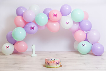 Fantastic colorful birthday girl cake with pastels balloons. Butterfly cake. Girl birthday celebration. Baby's first year. First year photoshoot.