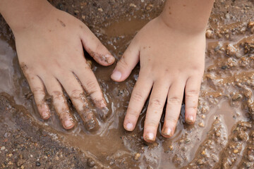 Hands Asian children dirty playing outside,