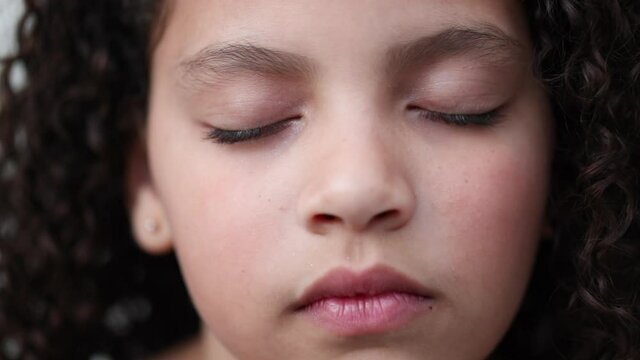 Little girl with eyes closed in contemplation and meditation