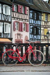 Fototapeta na wymiar View of vintage bicycle on medieval architecture background in Colmar - France