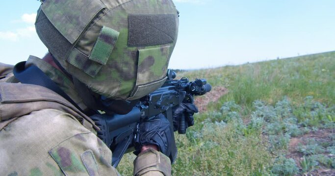 Russian army soldier holds a machine gun forward to attack the enemy on the battlefield.