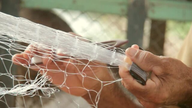 Fisherman restoring fishing net