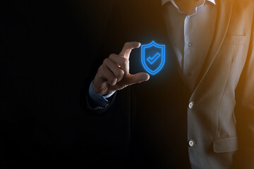 Protection network security computer in the hands of a businessman. business, technology, cyber security and internet concept - businessman pressing shield button on virtual screens Data protection