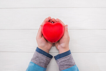 hands holding red heart, health care, love, organ donation, mindfulness, wellbeing, family insurance and CSR concept, world heart day, world health day, National Organ Donor Day,