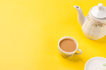 Milk tea on white cup with white kettle on yellow background stock image.