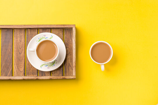 Milk tea on white cup with white kettle on yellow background stock image.
