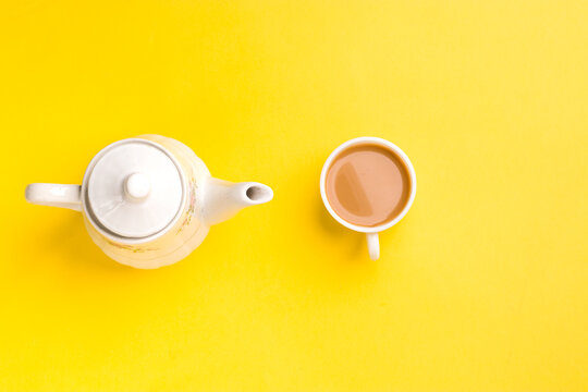 Milk tea on white cup with white kettle on yellow background stock image.