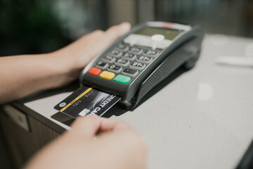 Credit card payment, buy and sell products & service. Woman with credit card swipe through terminal for sale
