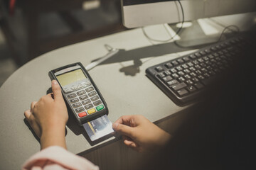 Credit card payment, buy and sell products & service. Woman with credit card swipe through terminal for sale