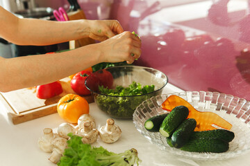 Cooking vegetarian salad with fresh vegetables