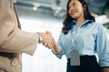 Fototapeta na wymiar Asian business woman leader making handshake . Close Up Of Two Women Shaking Hands. Two Businesswomen Shaking Hands In Modern Office