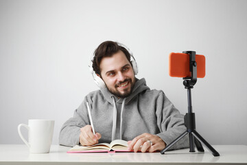 Headshot of bearded man studying online. Video conference via smartphone.