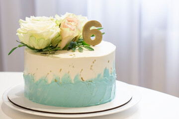 wedding  anniversary   cake  decorated  white and turquoise cream with natural roses and  gold number 6 on white background  with space for trxt . Birthday cake concept - obrazy, fototapety, plakaty