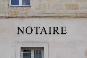 Fototapeta na wymiar Notaire french text sign means office entrance notary sign in wall building