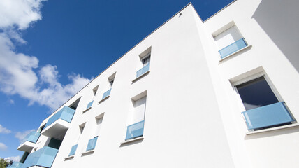 Modern residential white office building facades on blue sky