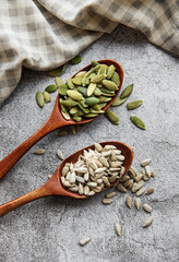 Wooden spoons with sunflower seeds and pumpkin seeds