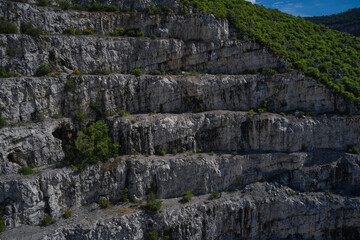 Italian marble quarries. Aerial view of an abandoned marble quarry. Panorama of developed mountain fossils. Top view of used mining in the alps.