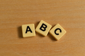 Alphabet letters with text ABC on wooden background