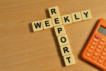 Top view of calculator and alphabet letters with text WEEKLY REPORT.