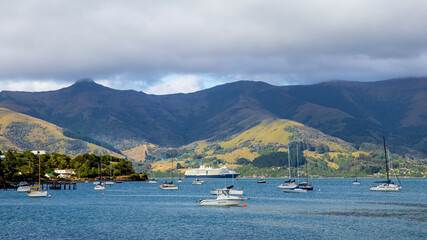 Fototapeta na wymiar Akaroa Boat Harbour. Akaroa is a small town on Banks Peninsula in the of the South Island of New Zealand. Travel and landscapes.