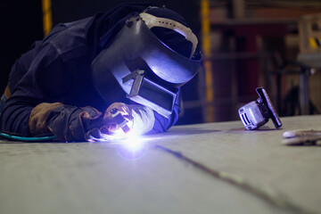 Skillful welders weld steel in the factory. Construction site metal welder.ll