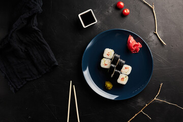 classic rolls on a plate on a black textured background top view